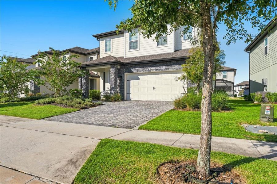 Front exterior of a new home in Reunion Village, Kissimmee, FL, highlighting curb appeal (Image 28).