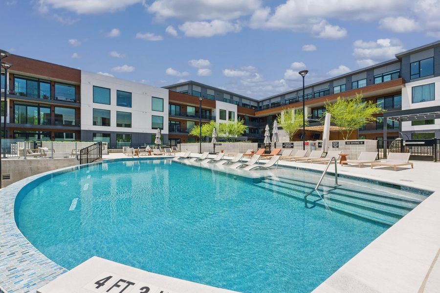 A sparkling pool invites relaxation, surrounded by comfortable loungers and contemporary architecture.