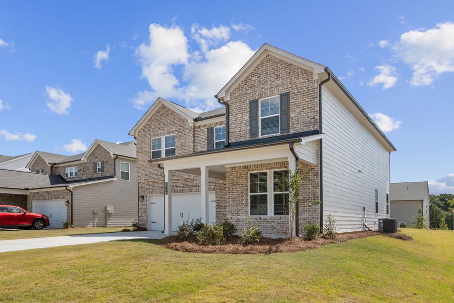 A house with a car parked in the driveway. A house with a car parked in the driveway.