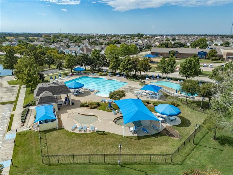 Aerial perspective of suburban area featuring a pool Aerial perspective of suburban area featuring a pool