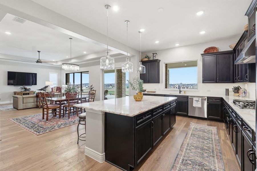 The Gourmet Cook’s Kitchen features GE Café Appliances, Cristal Gold Quartzite Island and Quartz Countertops, Upgraded Neutral Cabinetry, and a Large Picture Window capturing Golf Course and Territorial Views.