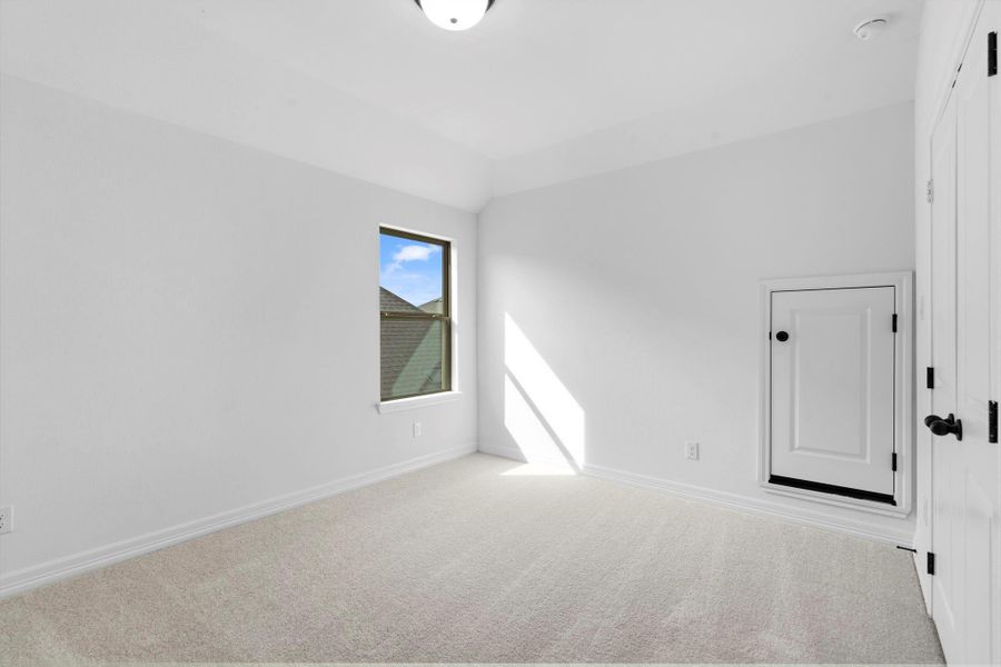 Bright fourth bedroom featuring a generous a large closet and ample natural light from large windows