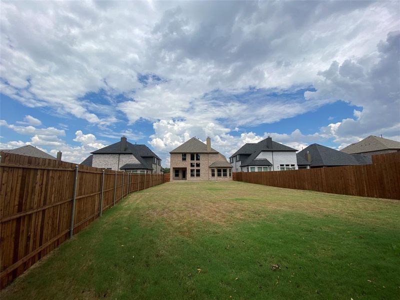 View of yard from back fence towards the home