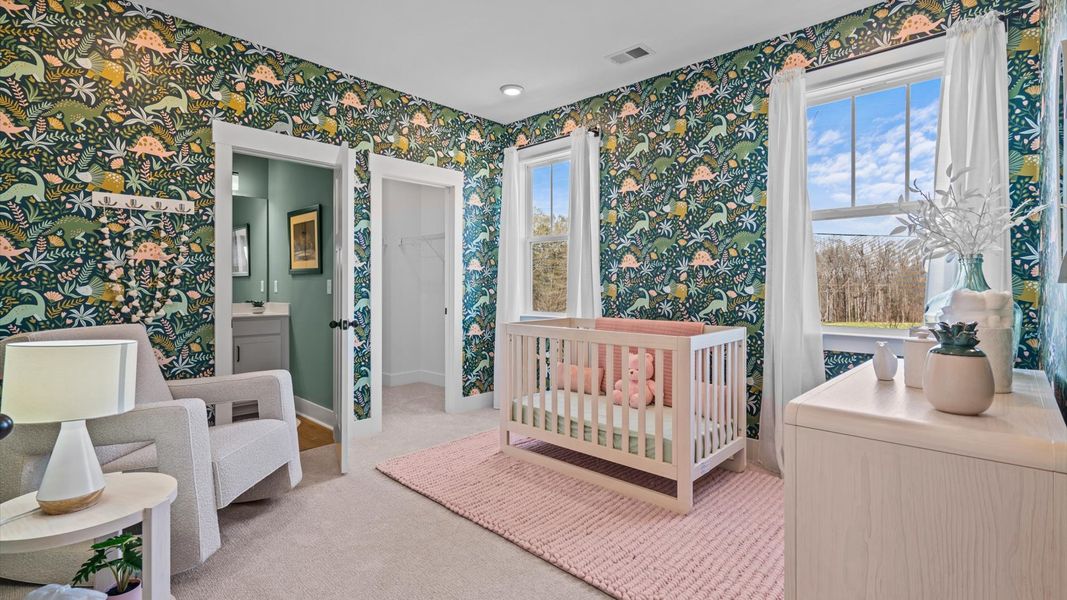 Highly functional bedroom with large windows, carpeted flooring, and tasteful finishes throughout