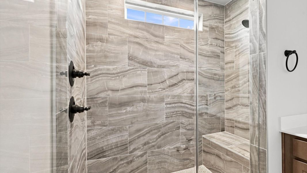 Exceptional en-suite with dual vanity and glass-enclosed walk-in shower for superior everyday comfort