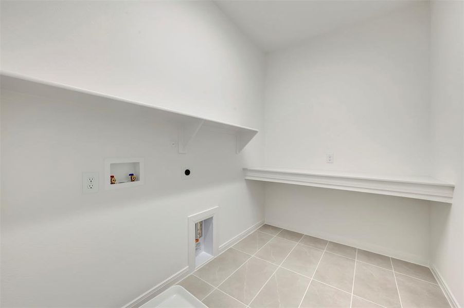 Laundry room with washer hookup, light tile patterned flooring, and hookup for an electric dryer