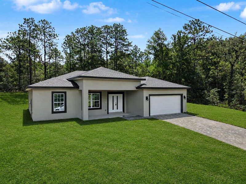 Front exterior of a new home in , Citrus Springs, FL, highlighting curb appeal (Image 22).