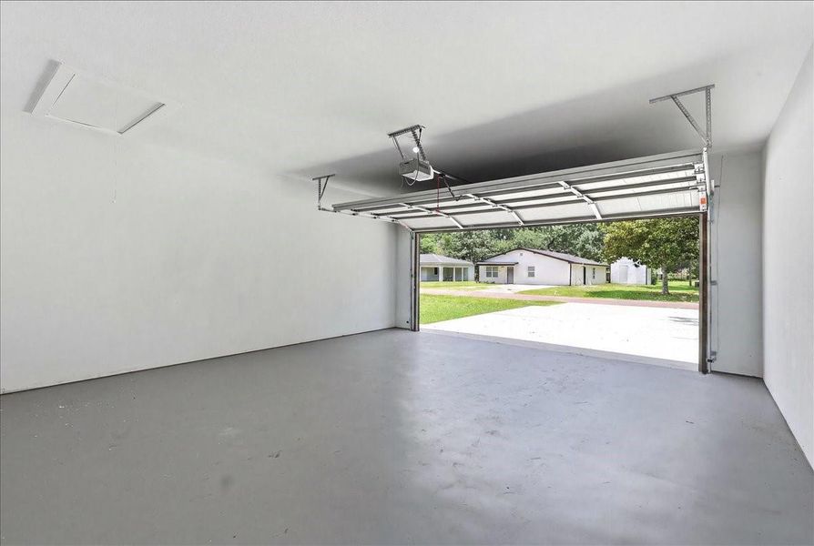 Finished and painted two-car garage with a clean gray epoxy-style floor finish. Finished and painted two-car garage with a clean gray epoxy-style floor finish.