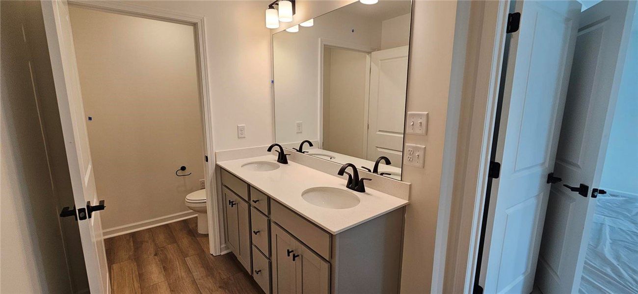 This bathroom features a contemporary double vanit