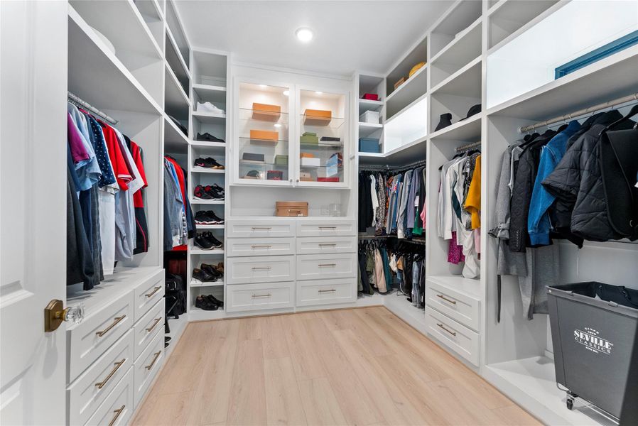 Custom primary closet offers boutique style organization with built ins, display shelving, and abundant hanging space. This level of storage is a meaningful luxury for buyers who value order and convenience.