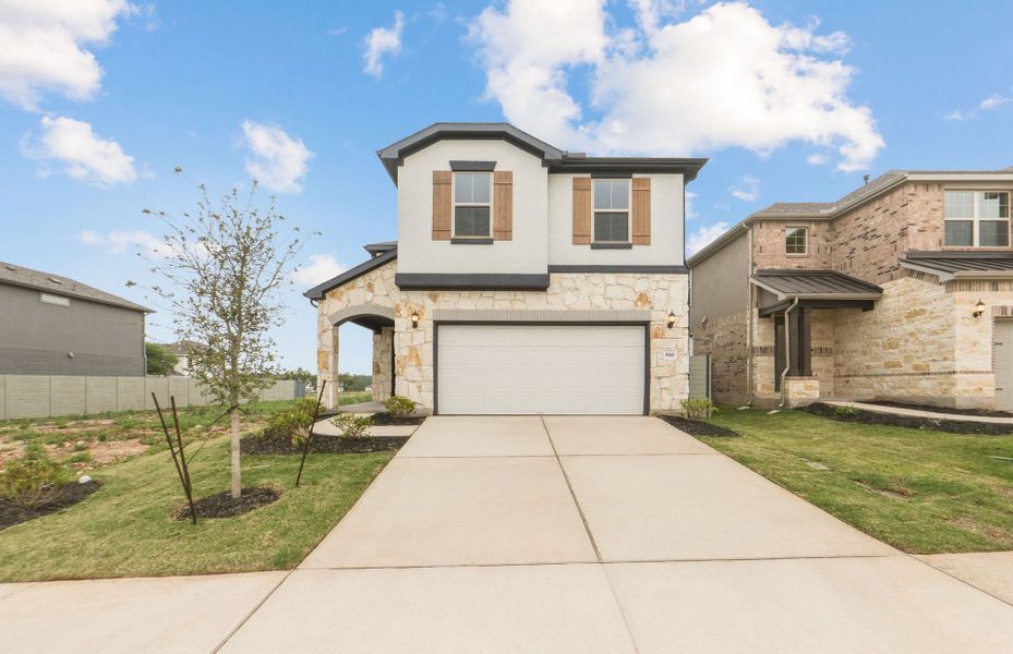 Front exterior of a new home in Wolf Ranch, Georgetown, TX, highlighting curb appeal (Image 25). Front exterior of a new home in Wolf Ranch, Georgetown, TX, highlighting curb appeal (Image 25).