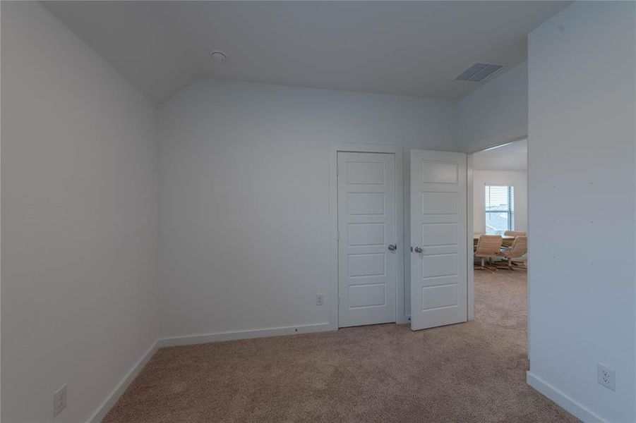 Full bath featuring vanity, toilet, tile patterned flooring, vaulted ceiling, and shower / tub combination