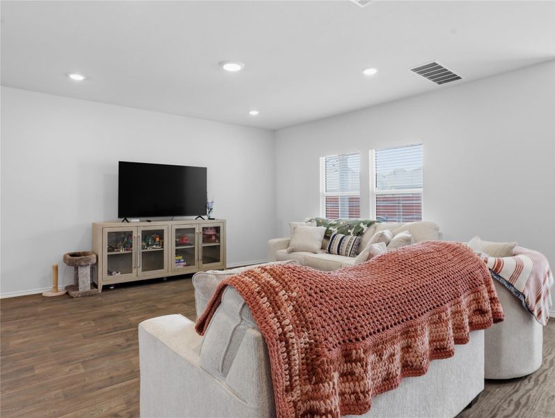 Recessed lighting and wide windows enhance this airy living space finished with durable plank flooring. Recessed lighting and wide windows enhance this airy living space finished with durable plank flooring.
