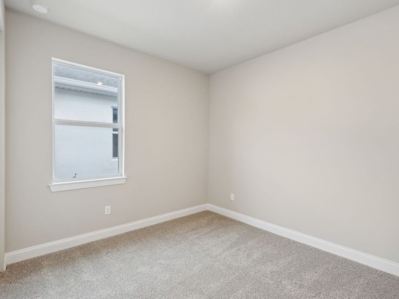 Bedroom in the Coral floorplan at 6398 NW Sweetwood Dr