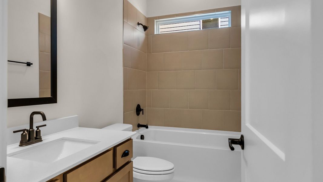 Secondary Bathroom with tiled shower (Representative of completed home)