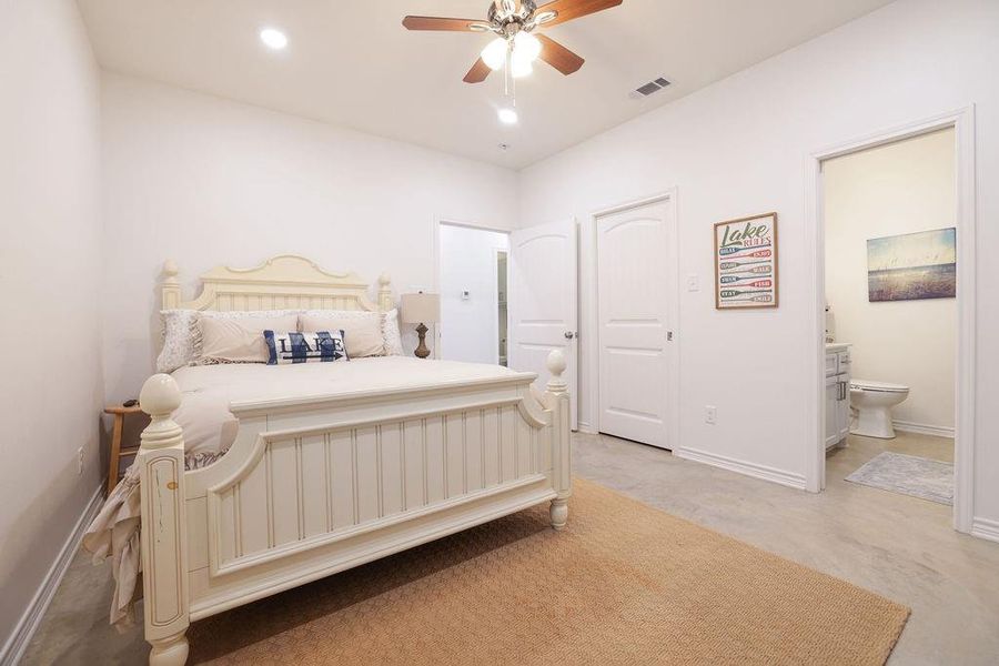 Bedroom with ensuite bathroom, ceiling fan, and recessed lighting