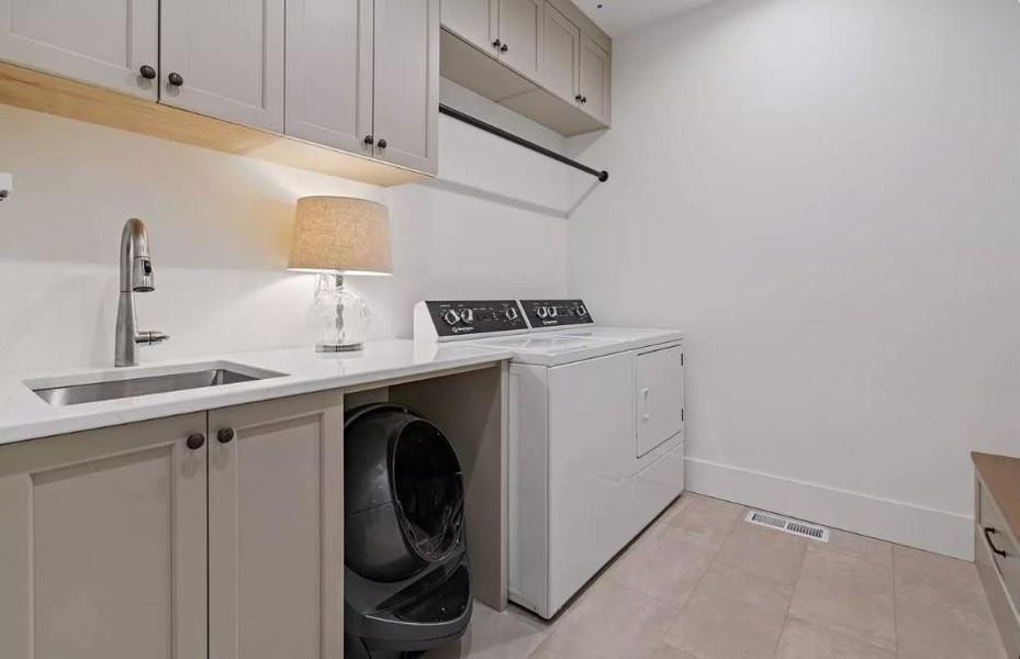 Laundry area featuring clothes drying hanging space with Sink and extra Storage