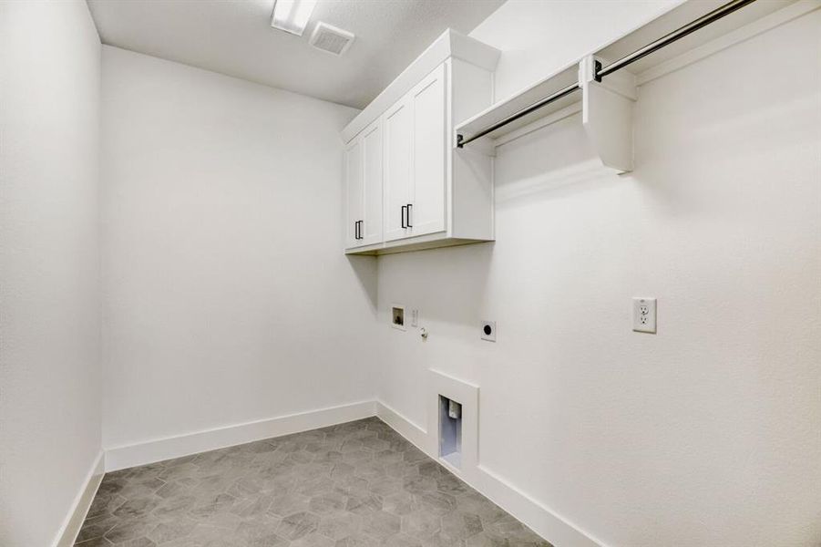Laundry room with electric dryer hookup, cabinet space, and hookup for a washing machine