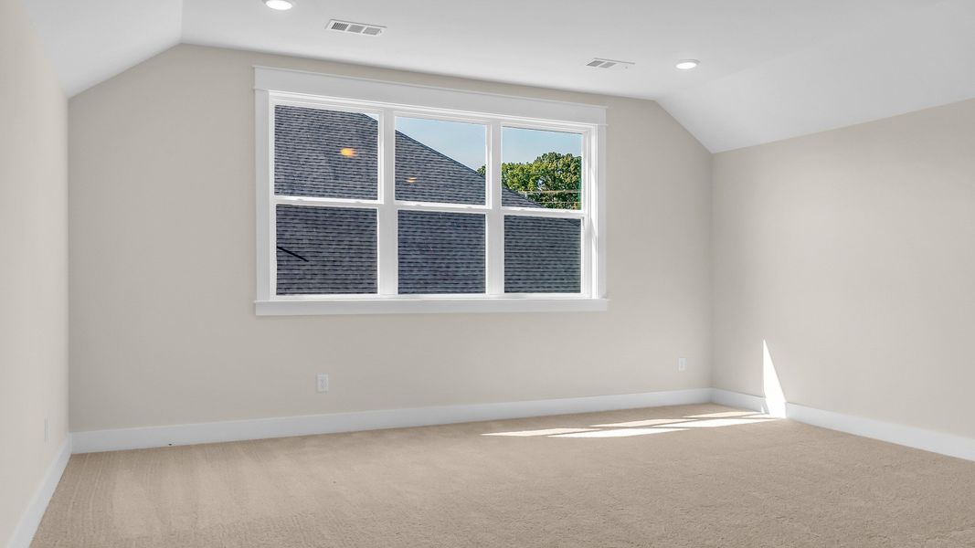 Second floor bonus room with vaulted ceiling and gorgeous triple windows (Representative of finished home)