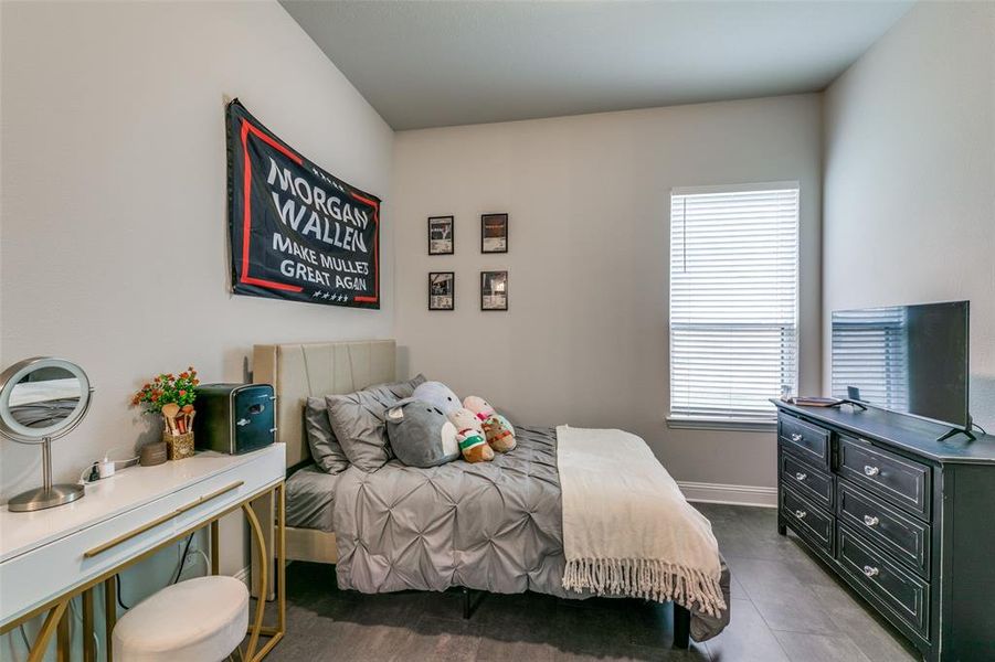 Tiled downstairs bedroom with multiple windows