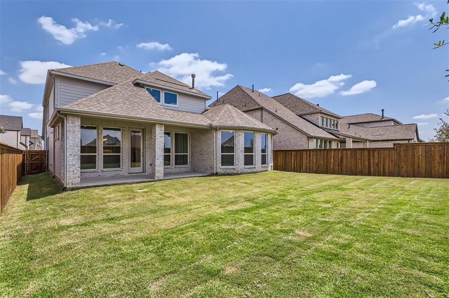 Back of house featuring a lawn