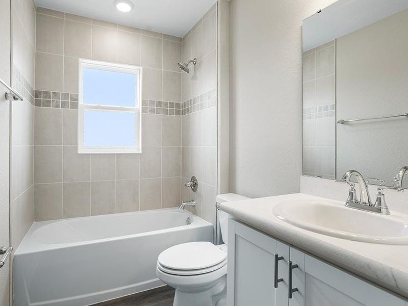 Secondary bedrooms and guests share a convenient hall bath - Paisley by Highland Homes