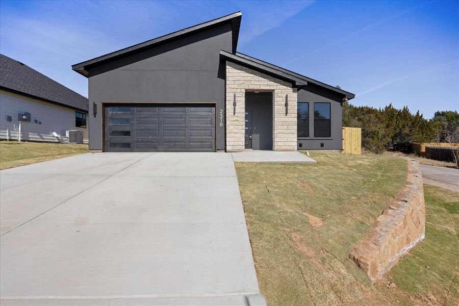 Front exterior of a new home in , Granbury, TX, highlighting curb appeal (Image 23).