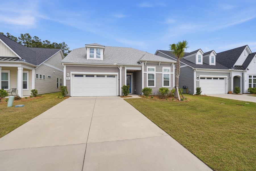 Front exterior of a new home in Summerwind Crossing at Lakes of Cane Bay, Summerville, SC, highlighting curb appeal (Image 21).