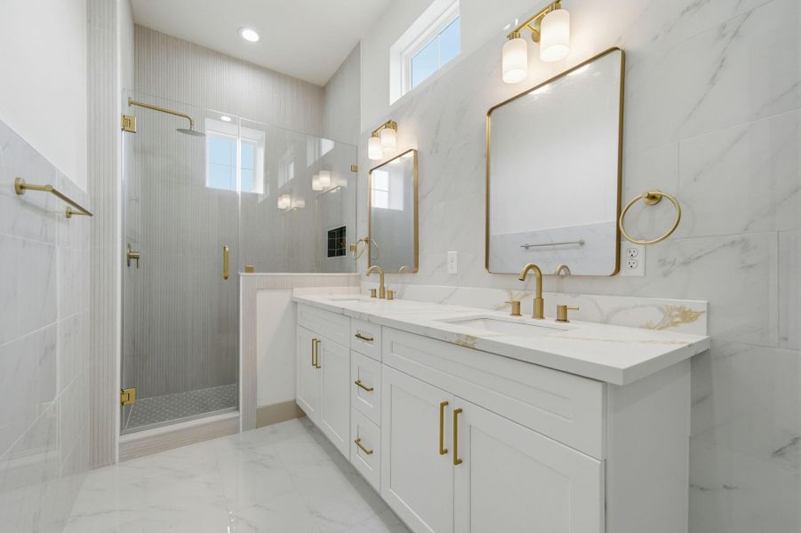 Good sized stand-up shower. Double sinks. Quartz counters continue in here. Windows up top for natural light!