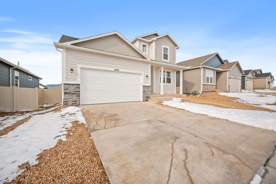 Front exterior of a new home in Aspen Ranch, Fountain, CO, highlighting curb appeal (Image 2). Front exterior of a new home in Aspen Ranch, Fountain, CO, highlighting curb appeal (Image 2).