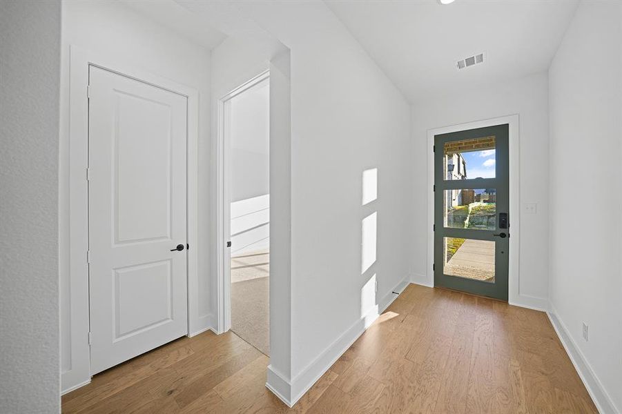 Foyer entrance with baseboards and light wood-style floors Foyer entrance with baseboards and light wood-style floors