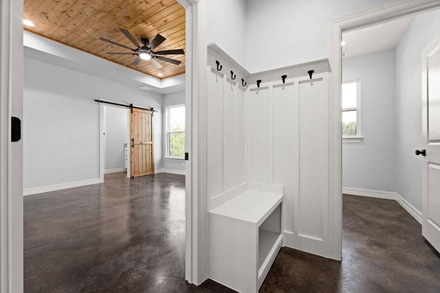 Mudroom featuring a barn door, ceiling fan, concrete floors, wood ceiling, and recessed lighting