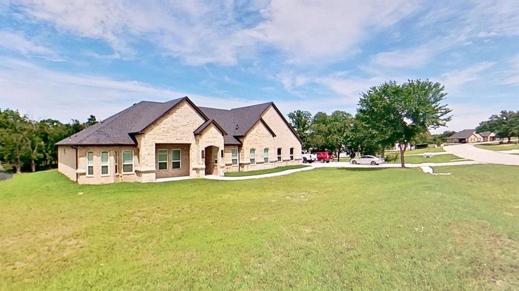 Contemporary brick exterior featuring a multi-gabled roofline, arched entry, and white-framed windows Contemporary brick exterior featuring a multi-gabled roofline, arched entry, and white-framed windows