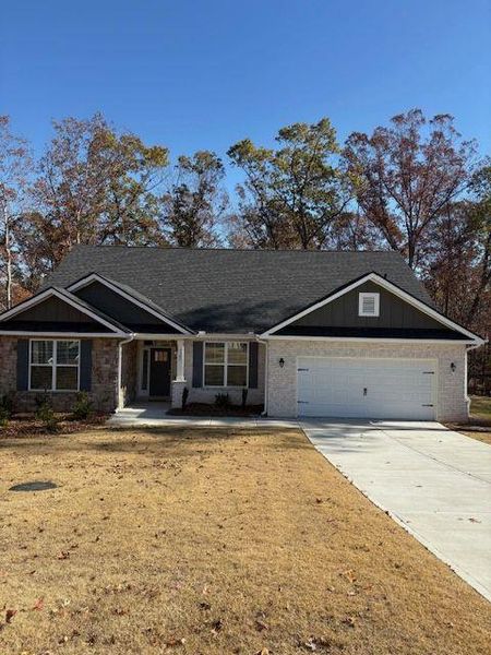 Front exterior of a new home in Tuscany Hills, Douglasville, GA, highlighting curb appeal (Image 1).