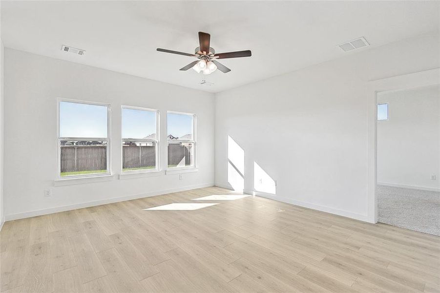 Spare room with ceiling fan and light hardwood / wood-style flooring