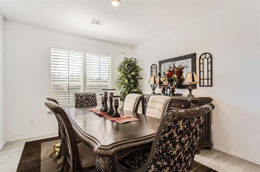 Formal dining room with plenty of natural light.