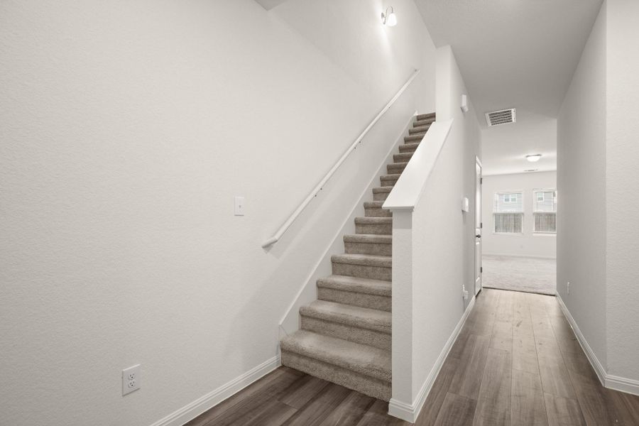 Stairway with baseboards and wood finished floors
