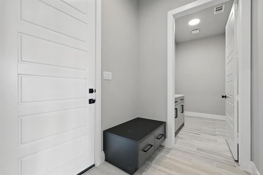 Mudroom featuring baseboards and light wood-style flooring Mudroom featuring baseboards and light wood-style flooring