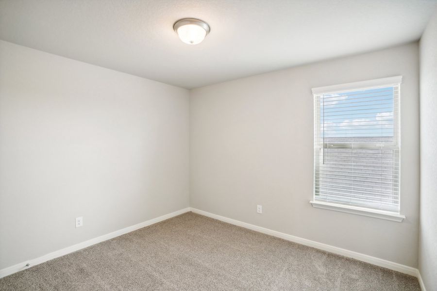 Guest bedroom of the Reynolds floorplan at a Meritage Homes community.