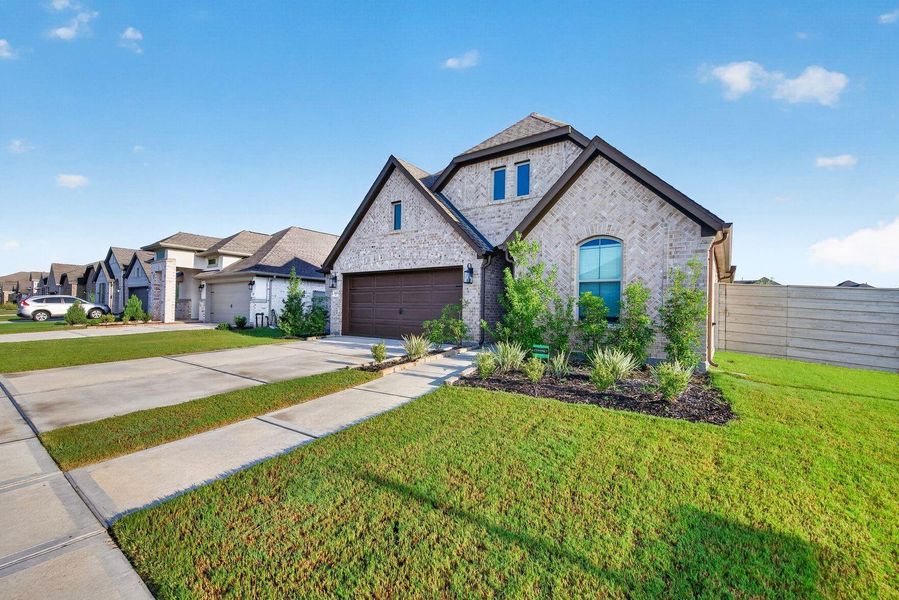 Front exterior of a new home in Pomona, Manvel, TX, highlighting curb appeal (Image 20).