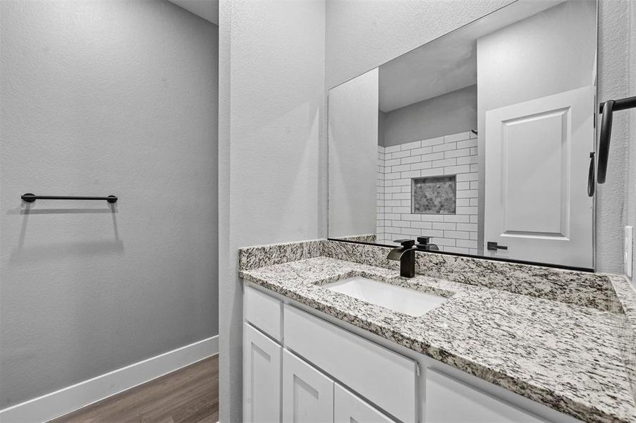 Bathroom with hardwood / wood-style floors and vanity