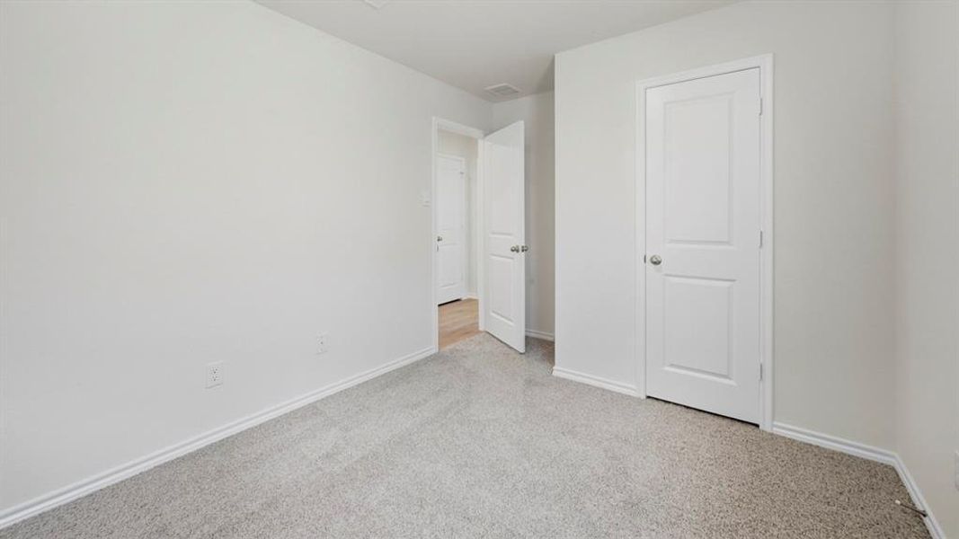 Unfurnished bedroom featuring carpet and baseboards Unfurnished bedroom featuring carpet and baseboards
