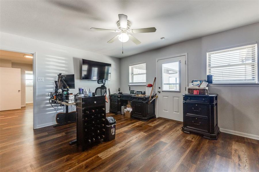 Office area with dark wood-type flooring and ceiling fan Office area with dark wood-type flooring and ceiling fan
