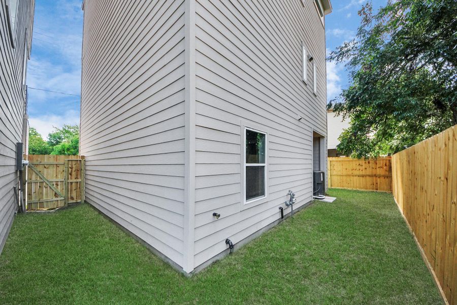 Gated side yard entrance leading to extended outdoor space