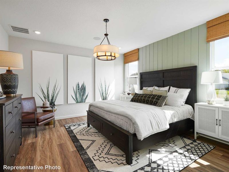 This inviting room features wood-look flooring and a light green accent wall