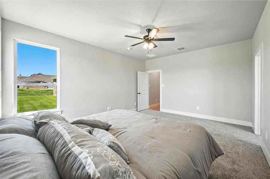 Bedroom featuring light colored carpet and ceiling fan