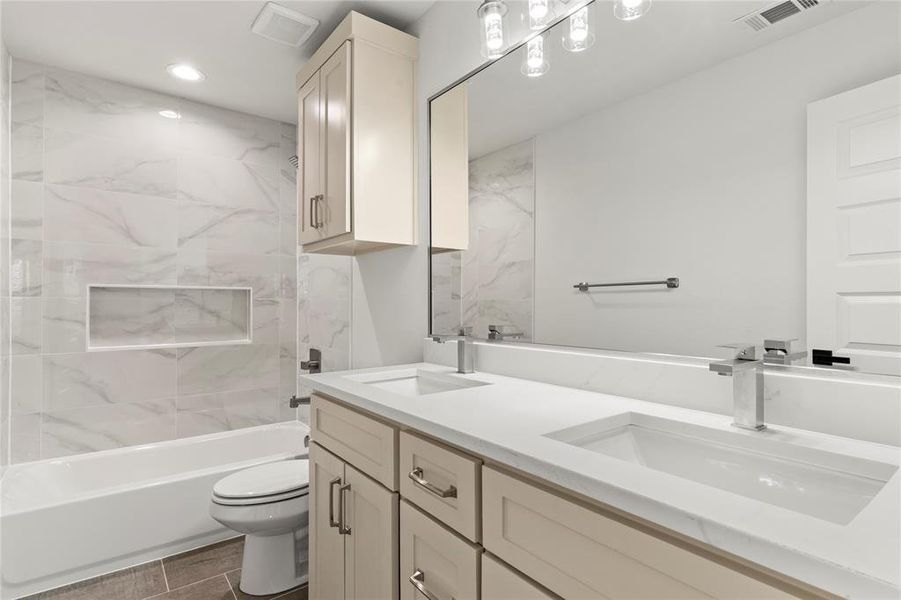 Bathroom featuring bathtub / shower combination, double vanity, and recessed lighting Bathroom featuring bathtub / shower combination, double vanity, and recessed lighting