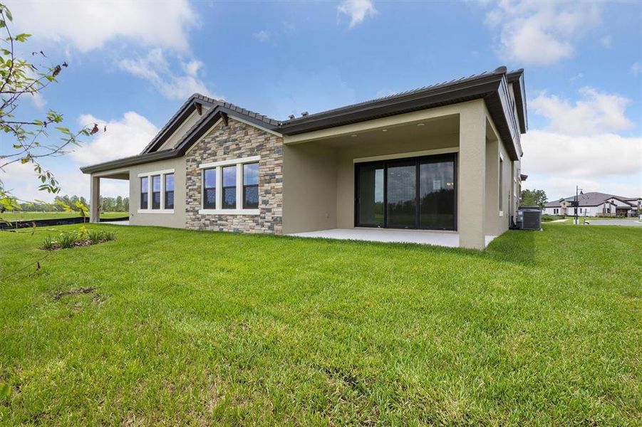 Front exterior of a new home in Two Rivers, Zephyrhills, FL, highlighting curb appeal (Image 1).