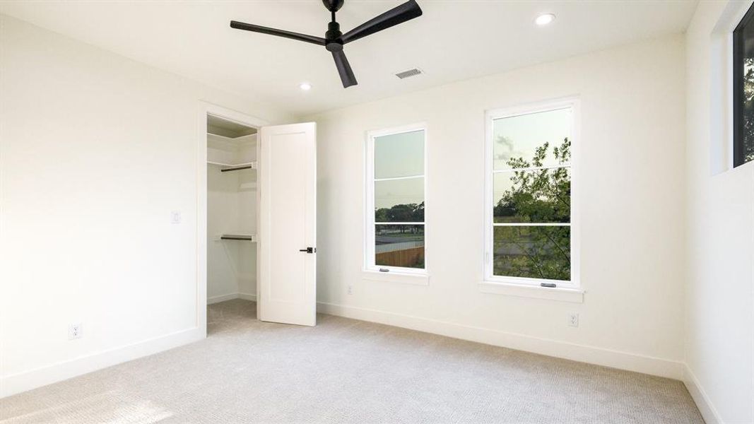 Unfurnished bedroom with light carpet, a closet, and ceiling fan