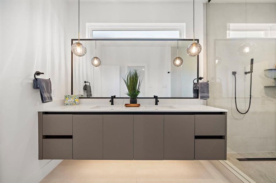 This modern vanity features a sleek, double-sink design with ample space for two. Clean lines and high-end finishes create a stylish, functional space, perfect for sharing while maintaining a clutter-free, organized look.